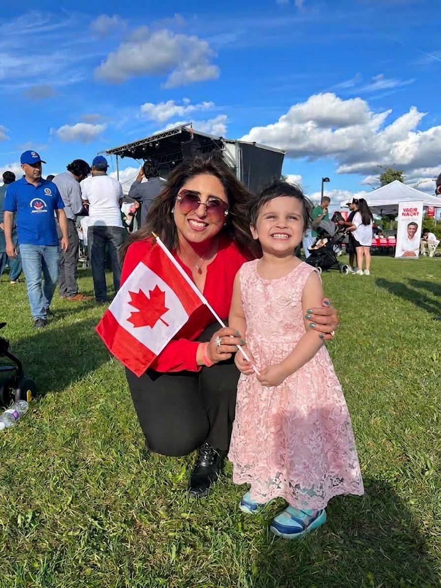 Saima Hammad celebrating Canada Day with a young community member